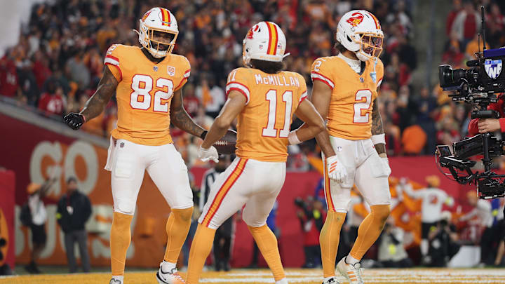 Former Huskies Devin Culp (82) and wide receiver Jalen McMillan (11) celebrate with the Tampa Bay Buccaneers.