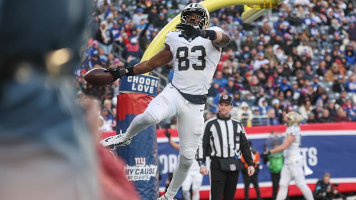 Dec 8, 2024; East Rutherford, New Jersey, USA; New Orleans Saints tight end Juwan Johnson (83) celebrates after a touchdown reception during the second half against the New York Giants at MetLife Stadium. Mandatory Credit: Vincent Carchietta-Imagn Images