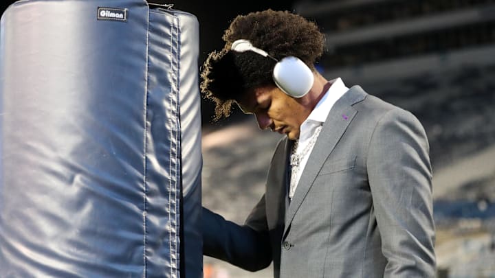 Nov 9, 2024; University Park, Pennsylvania, USA; Washington Huskies wide receiver Denzel Boston (12) leans against the goal post for a quiet moment prior to the game against the Penn State Nittany Lions at Beaver Stadium. Mandatory Credit: Matthew O'Haren-Imagn Images
