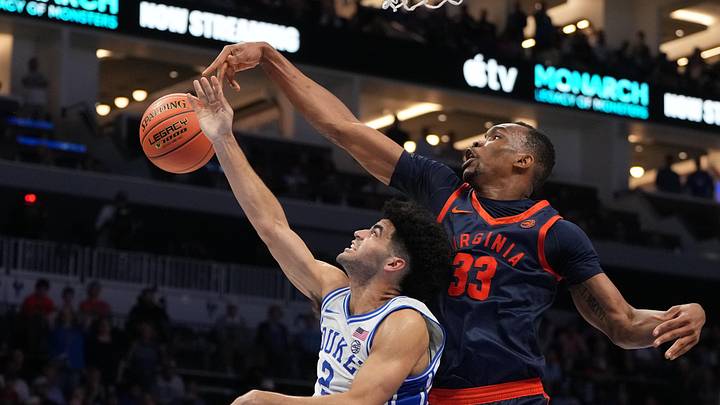 Mar 14, 2026; Charlotte, NC, USA; Virginia Cavaliers center Ugonna Onyenso (33) blocks the shot of Duke Blue Devils guard Cayden Boozer (2) in the second half during the men's ACC Conference Tournament Championship at Spectrum Center. Mandatory Credit: Bob Donnan-Imagn Images