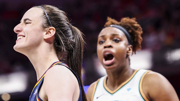 Jun 14, 2025; Indianapolis, Indiana, USA; Indiana Fever guard Caitlin Clark (22) smiles while New York Liberty forward Kennedy Burke (22) expresses frustration Saturday, June 14, 2025, during a game between the Indiana Fever and the New York Liberty at Gainbridge Fieldhouse. Mandatory Credit: Grace Smith-Imagn Images