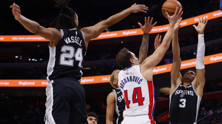 Jan 10, 2024; Detroit, Michigan, USA;  Detroit Pistons forward Bojan Bogdanovic (44) shoots on San Antonio Spurs forward Keldon Johnson (3) and guard Devin Vassell (24) in the first half at Little Caesars Arena. Mandatory Credit: Rick Osentoski-USA TODAY Sports