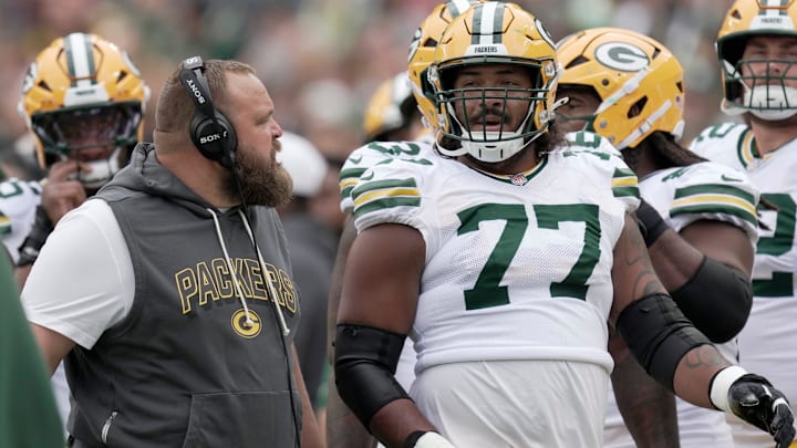 Green Bay Packers offensive tackle Jordan Morgan (77) listens to offensive line coach Luke Butkus during the first quarter of their preseason game Saturday, August 23, 2025 at Lambeau Field in Green Bay, Wisconsin. The Green Bay Packers beat the Seattle Seahawks 20-7.