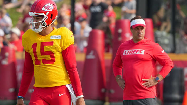 Jul 26, 2024; Kansas City, MO, USA; Kansas City Chiefs quarterback Patrick Mahomes (15) steps to the line as general manager Brett Veach watches in the background during training camp at Missouri Western State University. Mandatory Credit: Denny Medley-Imagn Images