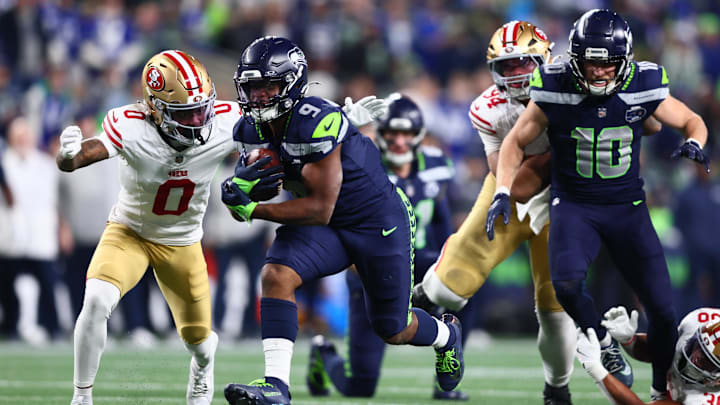 Jan 17, 2026; Seattle, WA, USA; Seattle Seahawks running back Kenneth Walker III (9) carries the ball as San Francisco 49ers cornerback Renardo Green (0) defends during the second half in an NFC Divisional Round game at Lumen Field. Mandatory Credit: Kevin Ng-Imagn Images