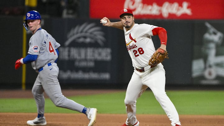 Jun 24, 2025; St. Louis, Missouri, USA;  St. Louis Cardinals third baseman Nolan Arenado (28) barehands a ground ball and throws out Chicago Cubs shortstop Dansby Swanson (not pictured) during the ninth inning at Busch Stadium. Mandatory Credit: Jeff Curry-Imagn Images