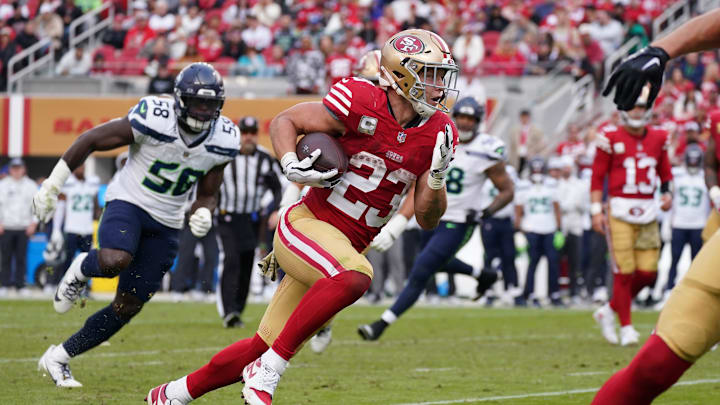 Nov 17, 2024; Santa Clara, California, USA; San Francisco 49ers running back Christian McCaffrey (23) rushes the ball while be pursued by Seattle Seahawks linebacker Derick Hall (58) in the fourth quarter at Levi's Stadium. Mandatory Credit: David Gonzales-Imagn Images Nov 17, 2024; Santa Clara, California, USA; San Francisco 49ers running back Christian McCaffrey (23) rushes the ball while be pursued by Seattle Seahawks linebacker Derick Hall (58) in the fourth quarter at Levi's Stadium. Mandatory Credit: David Gonzales-Imagn Images