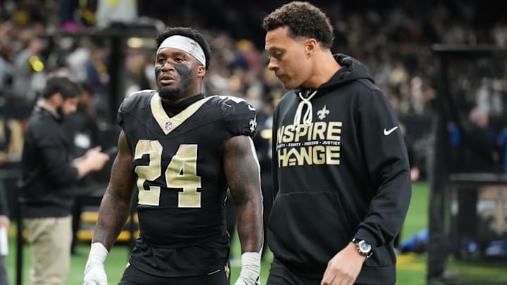 Dec 14, 2025; New Orleans, Louisiana, USA; New Orleans Saints running back Devin Neal (24) is walked off of the field after an injury during the second quarter against the Carolina Panthers at Caesars Superdome. Mandatory Credit: Matthew Hinton-Imagn Images Dec 14, 2025; New Orleans, Louisiana, USA; New Orleans Saints running back Devin Neal (24) is walked off of the field after an injury during the second quarter against the Carolina Panthers at Caesars Superdome. Mandatory Credit: Matthew Hinton-Imagn Images