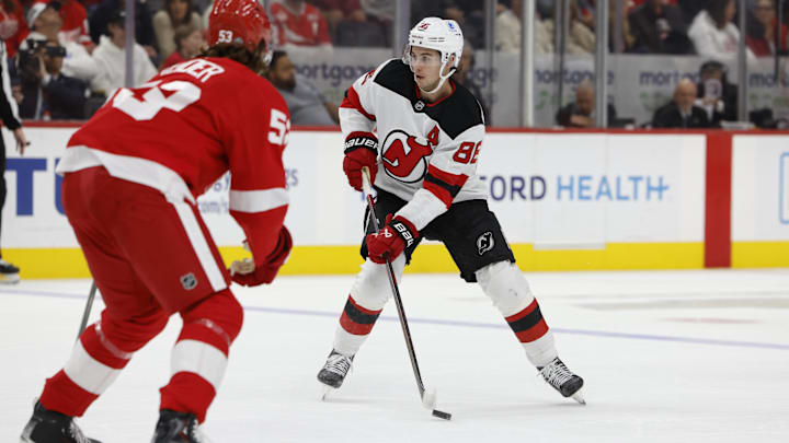 New Jersey Devils center Jack Hughes (86) defended by Detroit Red Wings defenseman Moritz Seider (53) Mandatory Credit: Rick Osentoski-Imagn Images