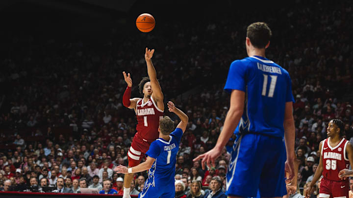 Dec 14, 2024; Tuscaloosa, Alabama, USA; Alabama Crimson Tide guard Mark Sears (1) attempts a long shot for the basket against Creighton Bluejays guard Steven Ashworth (1) and center Ryan Kalkbrenner (11) during the first half at Coleman Coliseum. Mandatory Credit: Will McLelland-Imagn Images