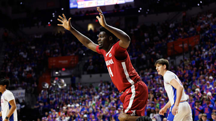 Feb 1, 2026; Gainesville, Florida, USA; Alabama Crimson Tide center Charles Bediako (14) calls for the ball while Florida Gators center Rueben Chinyelu (9) lays on the floor during the first half at Exactech Arena at the Stephen C. O'Connell Center. Mandatory Credit: Matt Pendleton-Imagn Images