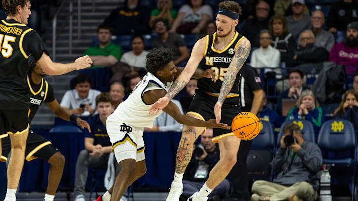 Dec 2, 2025; South Bend, Indiana, USA; Notre Dame Fighting Irish guard Markus Burton (3) dishes out a pass as Missouri Tigers forward Jacob Crews (35) defends during the second half at Purcell Pavilion at the Joyce Center. Mandatory Credit: Michael Caterina-Imagn Images