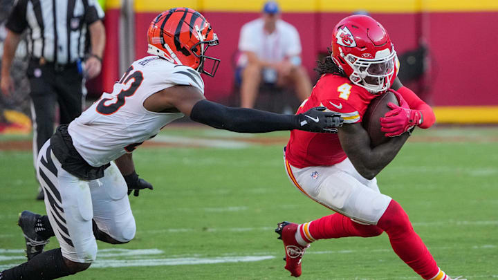 Sep 15, 2024; Kansas City, Missouri, USA; Kansas City Chiefs wide receiver Rashee Rice (4) runs the ball as Cincinnati Bengals cornerback Dax Hill (23) attempts the tackle during the game at GEHA Field at Arrowhead Stadium. Mandatory Credit: Denny Medley-Imagn Images
