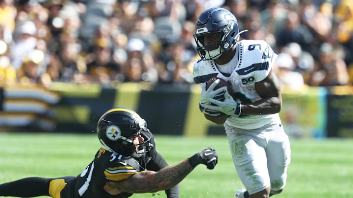 Sep 14, 2025; Pittsburgh, Pennsylvania, USA;  Seattle Seahawks running back Kenneth Walker III (9) runs the ball past Pittsburgh Steelers linebacker Nick Herbig (51) during the fourth quarter at Acrisure Stadium. Mandatory Credit: Charles LeClaire-Imagn Images
