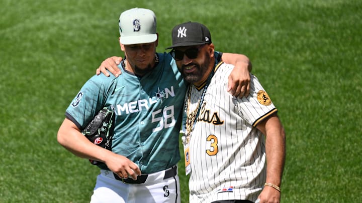 Jul 11, 2023; Seattle, Washington, USA; American League pitcher  Luis Castillo  of the Seattle Mariners (58) and musician The Kid Mero talk before the game at T-Mobile Park. Mandatory Credit: Steven Bisig-Imagn Images
