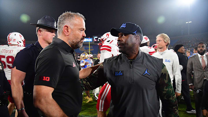 Nov 8, 2025; Pasadena, California, USA; Nebraska Cornhuskers head coach Matt Rhule meets with UCLA Bruins interim head coach Tim Skipper following the game at the Rose Bowl. Mandatory Credit: Gary A. Vasquez-Imagn Images