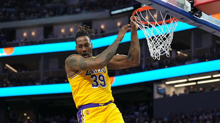 Apr 7, 2022; San Francisco, California, USA: Los Angeles Lakers center Dwight Howard (39) hangs on the rim after a dunk during the second quarter against the Golden State Warriors at Chase Center. Mandatory Credit: Darren Yamashita-Imagn Images