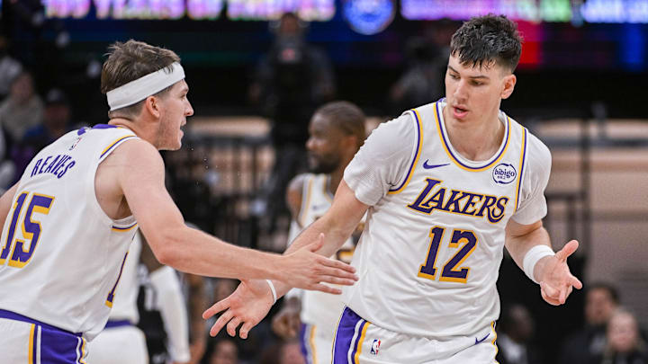 Oct 26, 2025; Sacramento, California, USA; Los Angeles Lakers forward Jake Laravia (12) high fives guard Austin Reaves (15) after scoring against the Sacramento Kings during the fourth quarter at Golden 1 Center. Mandatory Credit: Ed Szczepanski-Imagn Images