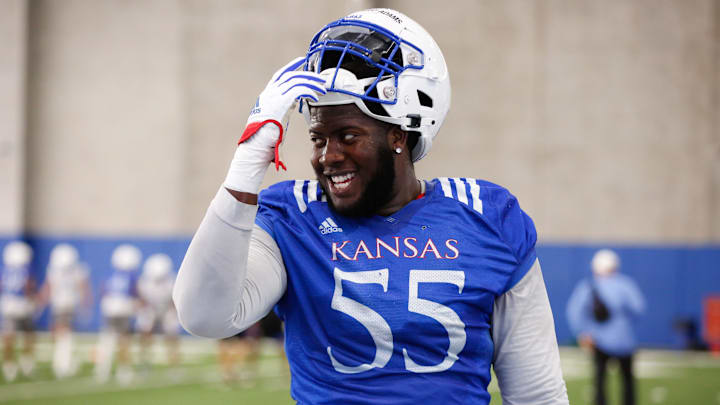 Kansas redshirt sophomore offensive lineman Ar'maj Reed-Adams (55) smiles during Tuesday's practice