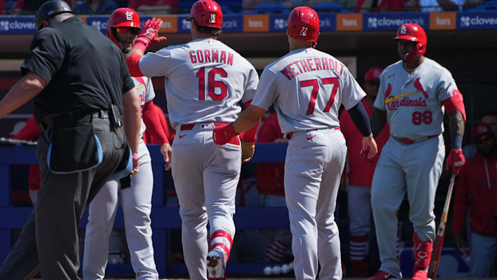 Feb 25, 2026; Port St. Lucie, Florida, USA; St. Louis Cardinals second baseman Nolan Gorman (16) celebrates a three-run home run against the New York Mets in the third inning with teammates Chase Davis, left, and JJ Wetherholt (77) at Clover Park. Mandatory Credit: Jim Rassol-Imagn Images Feb 25, 2026; Port St. Lucie, Florida, USA; St. Louis Cardinals second baseman Nolan Gorman (16) celebrates a three-run home run against the New York Mets in the third inning with teammates Chase Davis, left, and JJ Wetherholt (77) at Clover Park. Mandatory Credit: Jim Rassol-Imagn Images