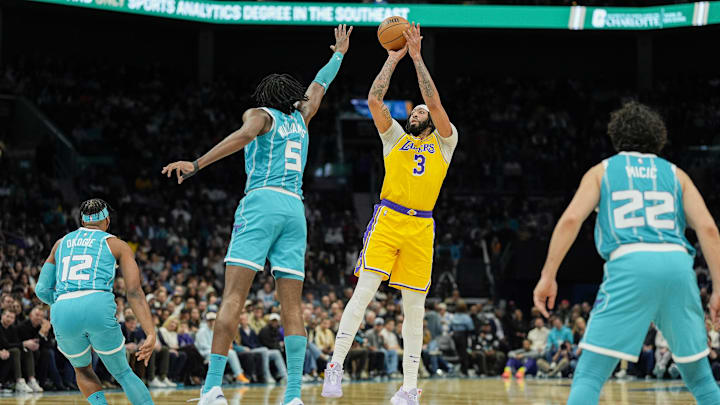 Jan 27, 2025; Charlotte, North Carolina, USA; Los Angeles Lakers forward Anthony Davis (3) shoots a three pointer over Charlotte Hornets center Mark Williams (5) during the first quarter at the Spectrum Center. Mandatory Credit: Jim Dedmon-Imagn Images