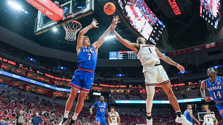 Kansas Jayhawks guard Kohl Rosario (7) battles Louisville Cardinals guard J'Vonne Hadley (1) for rebound during an exhibition game at the KFC Yum! Center in Louisville, Kentucky Friday, October 24, 2025. Kansas Jayhawks guard Kohl Rosario (7) battles Louisville Cardinals guard J'Vonne Hadley (1) for rebound during an exhibition game at the KFC Yum! Center in Louisville, Kentucky Friday, October 24, 2025.