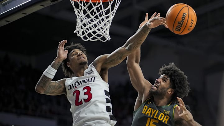 Feb 25, 2025; Cincinnati, Ohio, USA; Cincinnati Bearcats forward Dillon Mitchell (23) swats the ball away from Baylor Bears forward Norchad Omier (15) in the second half at Fifth Third Arena. Mandatory Credit: Aaron Doster-Imagn Images Feb 25, 2025; Cincinnati, Ohio, USA; Cincinnati Bearcats forward Dillon Mitchell (23) swats the ball away from Baylor Bears forward Norchad Omier (15) in the second half at Fifth Third Arena. Mandatory Credit: Aaron Doster-Imagn Images