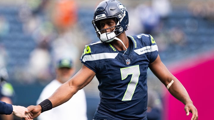 Sep 22, 2024; Seattle, Washington, USA; Seattle Seahawks quarterback Geno Smith (7) high fives a team member before the game against Miami Dolphins at Lumen Field. Mandatory Credit: Kevin Ng-Imagn Images