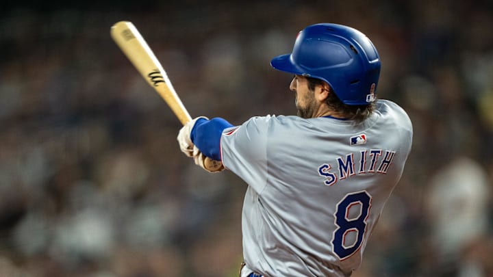 Sep 13, 2024; Seattle, Washington, USA;  Texas Rangers shortstop Josh Smith (8) hits a single during the first inning against the Seattle Mariners at T-Mobile Park. 