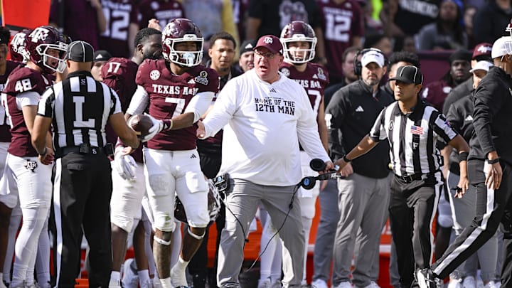 Dec 20, 2025; College Station, TX, USA; Texas A&M Aggies head coach Mike Elko reacts to a call during the game between the Aggies and the Hurricanes at Kyle Field. Mandatory Credit: Jerome Miron-Imagn Images
