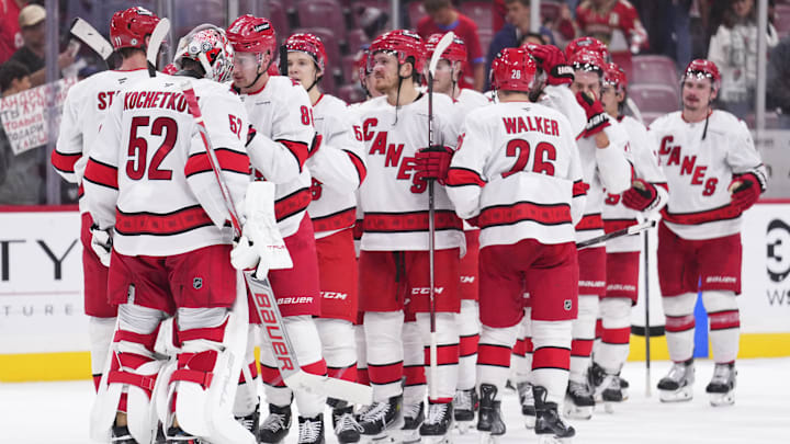 Jan 2, 2025; Sunrise, Florida, USA; Carolina Hurricanes goaltender Pyotr Kochetkov (52) is congrulted by teammtes after defeating the Florida Panthers at Amerant Bank Arena. Mandatory Credit: Rich Storry-Imagn Images