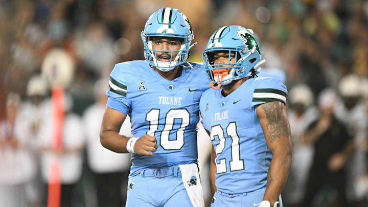 Tulane Green Wave players Darian Mensah (10) and Makhi Hughes (21) stand next to each other.
