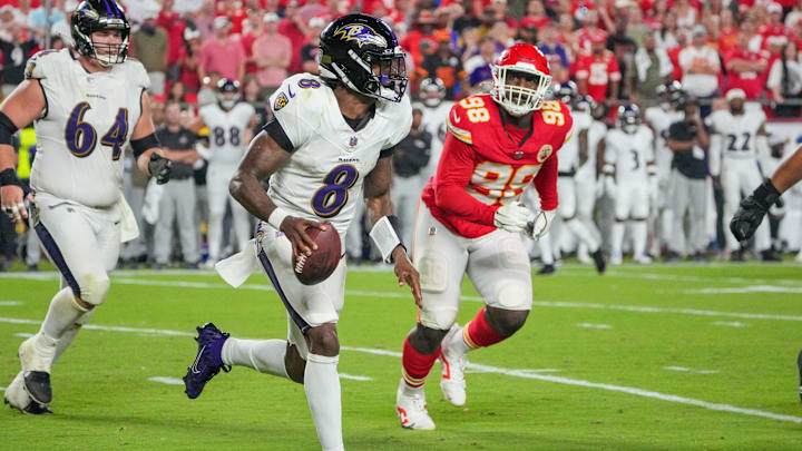 Sep 5, 2024; Kansas City, Missouri, USA; Baltimore Ravens quarterback Lamar Jackson (8) runs the ball as Kansas City Chiefs defensive tackle Tershawn Wharton (98) chases during the second half at GEHA Field at Arrowhead Stadium. Mandatory Credit: Denny Medley-Imagn Images