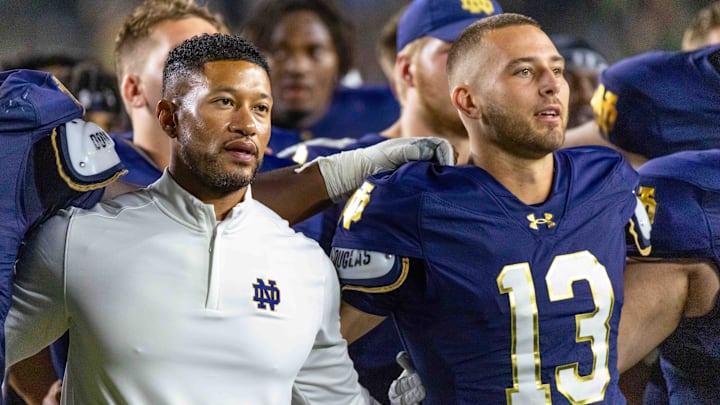 Sep 20, 2025; South Bend, Indiana, USA; Notre Dame Fighting Irish head coach Marcus Freeman and quarterback CJ Carr (13) sing the alma mater after beating the Purdue Boilermakers at Notre Dame Stadium. 