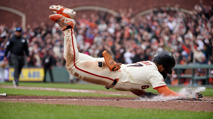 Apr 27, 2025; San Francisco, California, USA; San Francisco Giants outfielder Heliot Ramos (17) scores the walk-off run against the Texas Rangers during the ninth inning at Oracle Park. Robert Edwards-Imagn Images