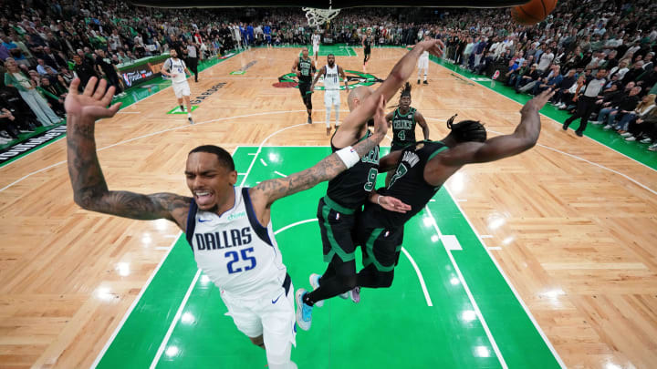 Jun 9, 2024; Boston, Massachusetts, USA; Dallas Mavericks forward P.J. Washington (25) reacts after losing control of the ball against Boston Celtics guard Derrick White (9) and guard Jaylen Brown (7) during the fourth quarter in game two of the 2024 NBA Finals at TD Garden. Mandatory Credit: Peter Casey-USA TODAY Sports