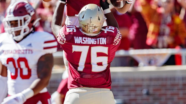 Florida State Seminoles quarterback Jordan Travis (13) is lifted up by Florida State Seminoles