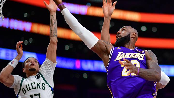 Jan 9, 2026; Los Angeles, California, USA; Los Angeles Lakers forward LeBron James (23) shoots against Milwaukee Bucks guard Ryan Rollins (13) during the second half at Crypto.com Arena. Mandatory Credit: Gary A. Vasquez-Imagn Images