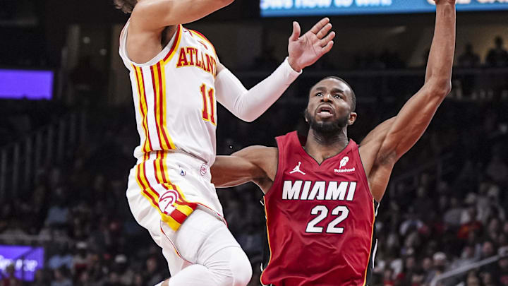 Feb 24, 2025; Atlanta, Georgia, USA; Atlanta Hawks guard Trae Young (11) shoots over top of Miami Heat forward Andrew Wiggins (22) during the second half at State Farm Arena. Mandatory Credit: Dale Zanine-Imagn Images