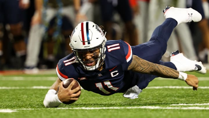 Oct 5, 2024; Tucson, Arizona, USA; Arizona Wildcats quarterback Noah Fifita (11) dives for a first down against Texas Tech Red Raiders during third quarter at Arizona Stadium
