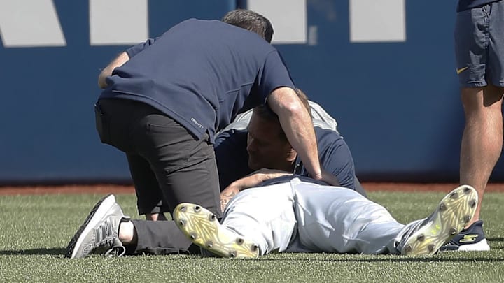 Apr 22, 2024; Pittsburgh, Pennsylvania, USA;  Milwaukee Brewers trainers examine relief pitcher
