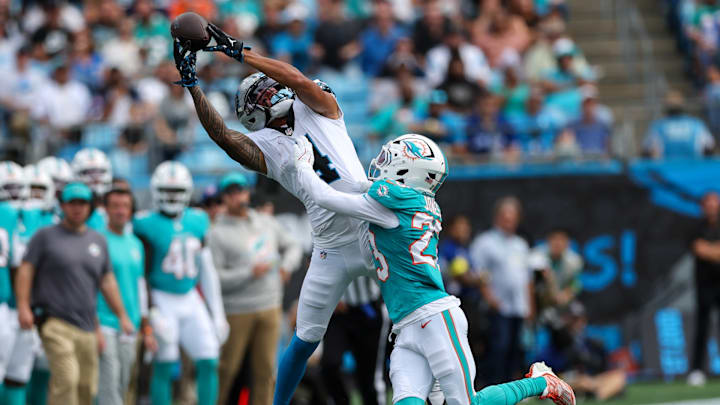 Oct 5, 2025; Charlotte, North Carolina, USA; Carolina Panthers wide receiver Tetairoa McMillan (4) reaches for a pass with Miami Dolphins cornerback Jack Jones (23) defending during the third quarter at Bank of America Stadium. Oct 5, 2025; Charlotte, North Carolina, USA; Carolina Panthers wide receiver Tetairoa McMillan (4) reaches for a pass with Miami Dolphins cornerback Jack Jones (23) defending during the third quarter at Bank of America Stadium.
