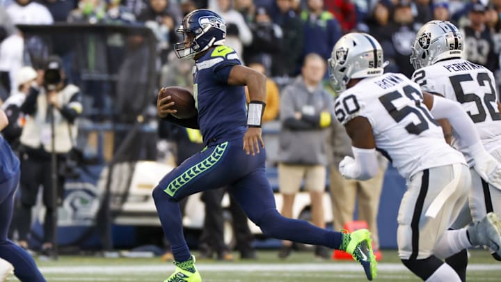 Nov 27, 2022; Seattle, Washington, USA; Seattle Seahawks quarterback Geno Smith (7) scrambles against the Las Vegas Raiders during the fourth quarter at Lumen Field. 