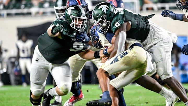 Michigan State's Jalen Thompson, right, tackles Florida Atlantic's Cam Fancher during the fourth quarter on Friday, Aug. 30, 2024, at Spartan Stadium in East Lansing.