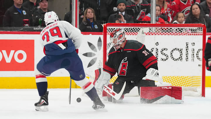 Nov 11, 2025; Raleigh, North Carolina, USA;  Carolina Hurricanes goaltender Frederik Andersen (31) stops the shot attempt by Washington Capitals center Hendrix Lapierre (29) during the first period at Lenovo Center. Mandatory Credit: James Guillory-Imagn Images