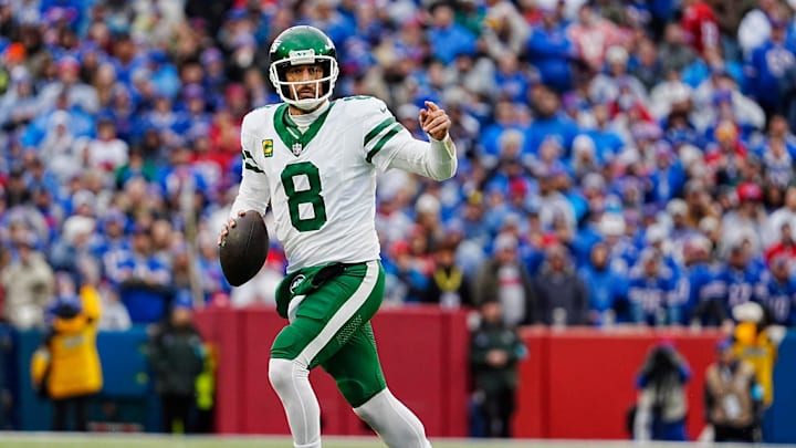 New York Jets quarterback Aaron Rodgers (8) breaks away on a fake hand-off looking for an open receiver during first half action at the Bills home game against the New York Jets at Highmark Stadium in Orchard Park on Dec. 29, 2024. His pass was incomplete.