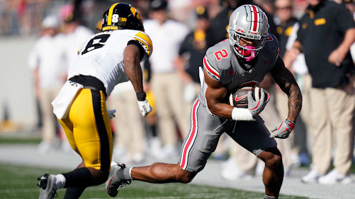Oct 5, 2024; Columbus, OH, USA; Ohio State Buckeyes wide receiver Emeka Egbuka (2) makes a catch against Iowa Hawkeyes defensive back Deshaun Lee (8) in the first quarter during the NCAA football game at Ohio Stadium.