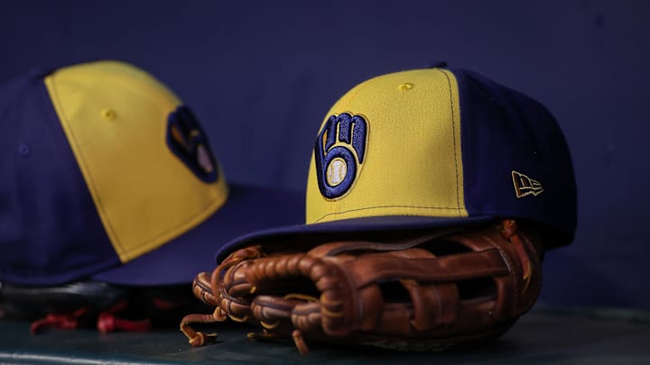 Jul 28, 2023; Atlanta, Georgia, USA; A detailed view of a Milwaukee Brewers hat and glove on the bench against the Atlanta Braves in the second inning at Truist Park. Mandatory Credit: Brett Davis-Imagn Images