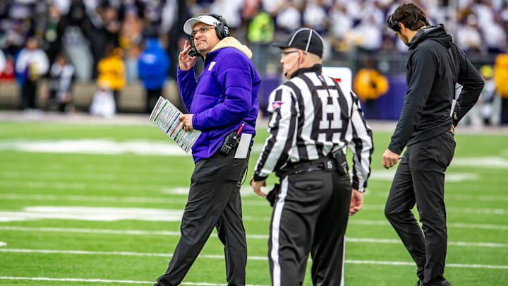 Jedd Fisch listens on his headset during the Oregon game. Jedd Fisch listens on his headset during the Oregon game.