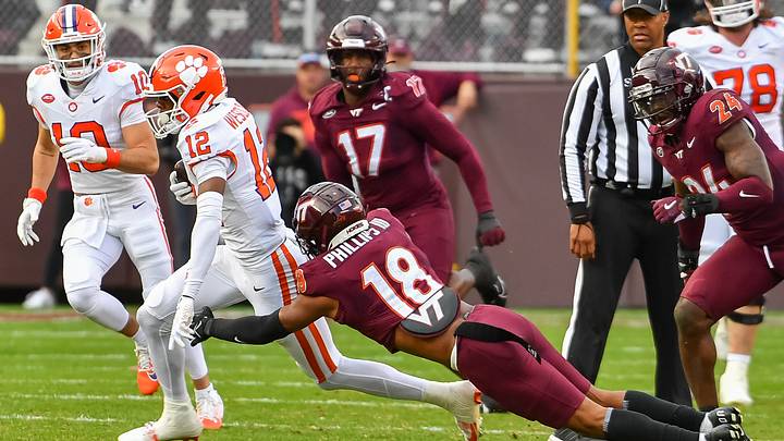 Nov 9, 2024; Blacksburg, Virginia, USA; .Virginia Tech Hokies safety Mose Phillips III (18) dives to tackle Clemson Tigers wideout Bryant Wesco Jr. (12) during the first quarter at Lane Stadium. Mandatory Credit: Brian Bishop-Imagn Images Nov 9, 2024; Blacksburg, Virginia, USA; .Virginia Tech Hokies safety Mose Phillips III (18) dives to tackle Clemson Tigers wideout Bryant Wesco Jr. (12) during the first quarter at Lane Stadium. Mandatory Credit: Brian Bishop-Imagn Images